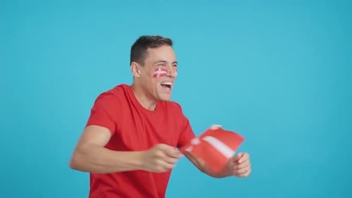 Excited Man Waving Flag Celebrates Success