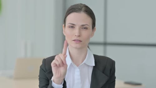 Woman Gesturing No in an Office Workplace