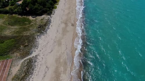 Aerial Top-Down Drone Flies Over Beach, Tilting Up to Reveal Long Coastline, Turquoise Sea
