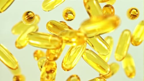 Golden Vitamin Capsules Floating