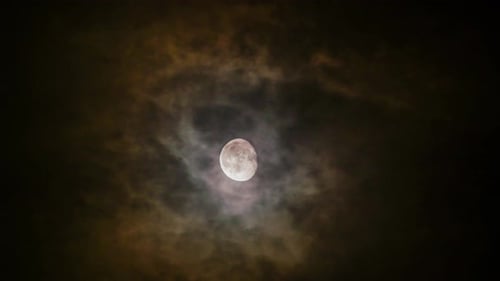 Full Moon Through Dark Clouds at Night