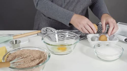 Cracking Eggs into Bowl for Baking Recipe