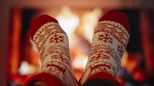 Festive Socks Propped Up by the Fire, Creating a Cozy Christmas Eve Scene.