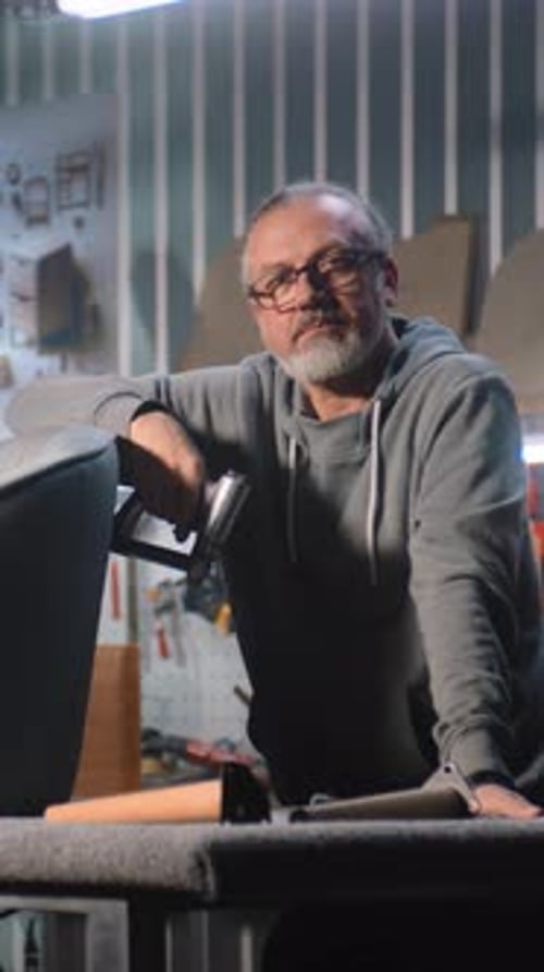 Two Professional Craftsmen Stand and Look at Camera in Furniture Workshop