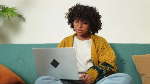 African American Girl Using Laptop at Home Office Looking at Screen Typing Chatting Reading Writing