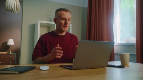 Man Working From Home Using Laptop Computer
