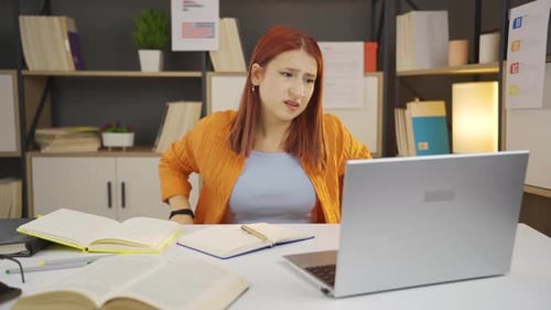Woman Frustrated with Laptop, Studying at Desk