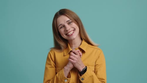 Young Woman Smiling Expressively in a Studio Portrait