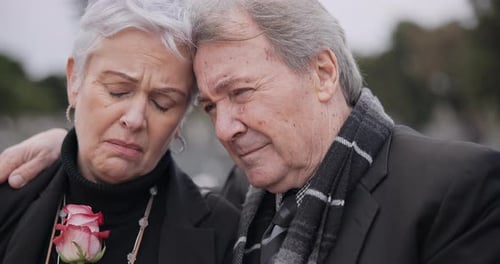 Funeral, graveyard and senior couple hug for comfort, empathy and support at memorial service