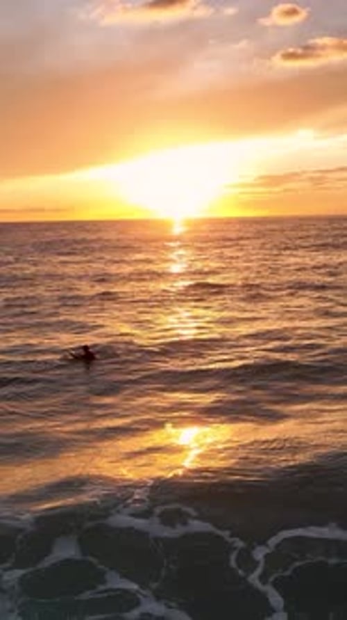 Vertical Video Serene Sunset Surfing Mesmerizing Footage of Surfers Riding the Waves
