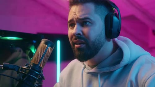 Man Talking Into Microphone with Headphones On