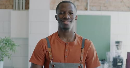 Young Adult Man Smiling in Cafe, Close Up