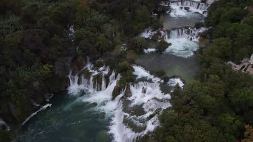 Aerial view of serene waterfall cascade in lush forest, Skradinski Buk, Croatia.