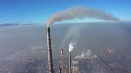 smoking and polluting pipes against the backdrop of smog-covered city