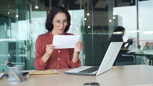 Woman Receives Good News in Office, Happy and Smiling