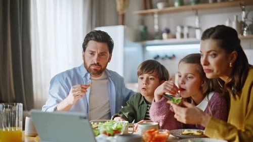 Family enjoys healthy lunch together at kitchen table