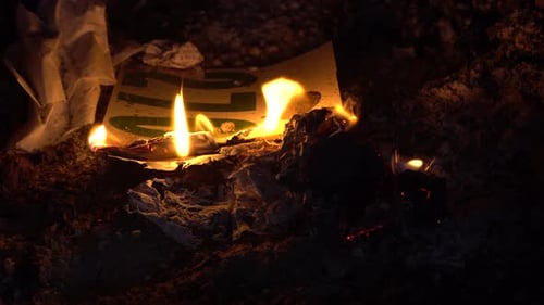 Paper Ablaze at Night Consumed by Fire