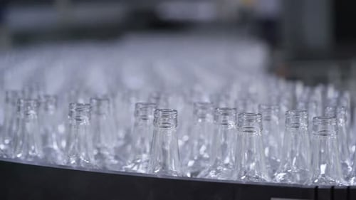Glass Bottle Factory. Conveyor Belt. Focus on Bottles on a Conveyor Belt