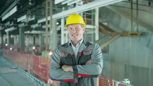 Construction Worker Indoors Engineer Man Building Smiling Looking at Camera at Construction Site