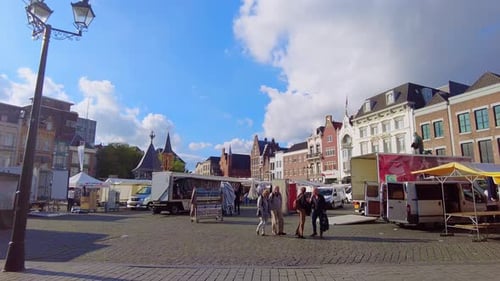 wide shot old market square in den bosch weekly market being packed. people walking by the netherlan