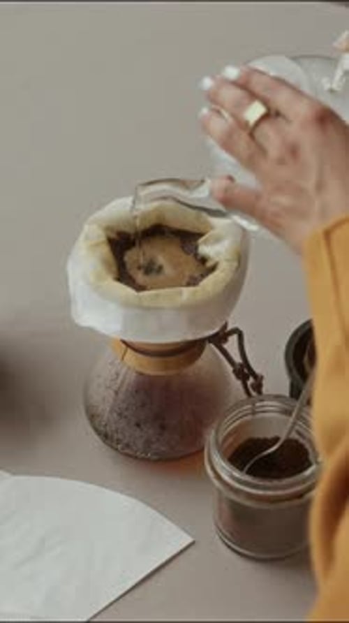 Pouring Clear Liquid Into Coffee Filter in Slow Motion