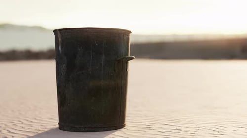 Gray Metal Garbage Bin or Trash Can on the Beach