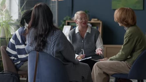 People Sitting in Group Therapy Session Indoors