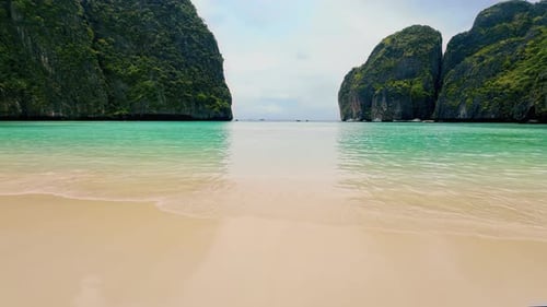 Paradise island sandy beach and clean turquoise water waves. Tropical beach space area, wild lagoon