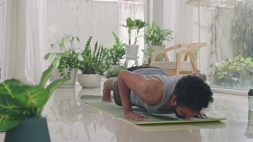 Man Doing Push-Ups on Yoga Mat Indoors