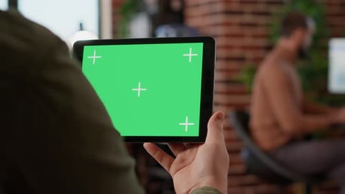 Tablet With Green Screen Held in Office