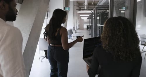 Business People with Laptop Walking in Modern Office Corridor Business