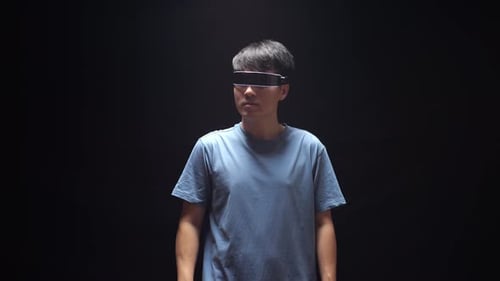 Asian Man Experience Virtual Reality In Futuristic Goggles. Player Touching Air Panel