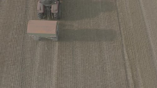 Aerial View of Farmer Fertilizing Agricultural Field Spreading Mineral Fertilizer in Slow Motion