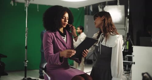 Makeup Artist Applying Makeup to Woman on Film Set