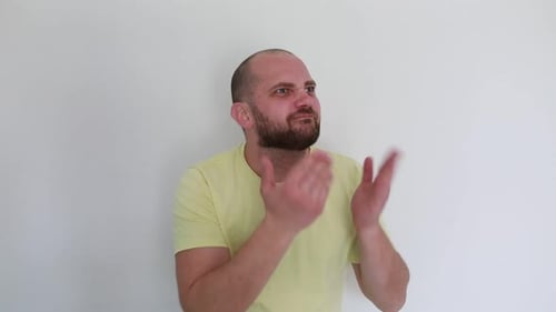 Man in Yellow TShirt Expressing Confusion Indoors During Daytime