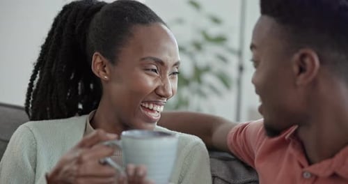 Woman Smiling and Laughing with Friend on Couch
