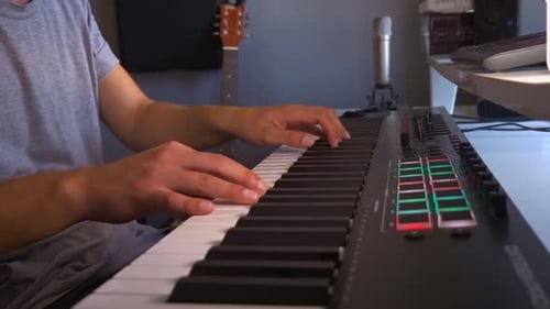 Man Playing Keyboard in Music Studio