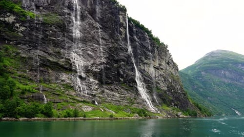 Water running through the Seven Sisters waterfall in the Geiranger Fjord, Norway