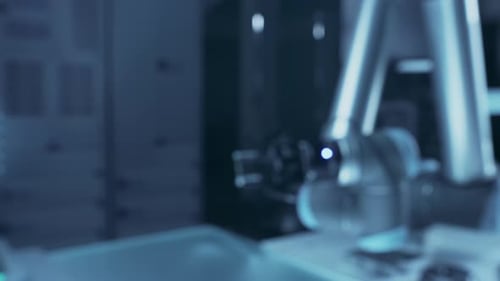 Robotic Arm Holding Computer Chip in Futuristic Lab