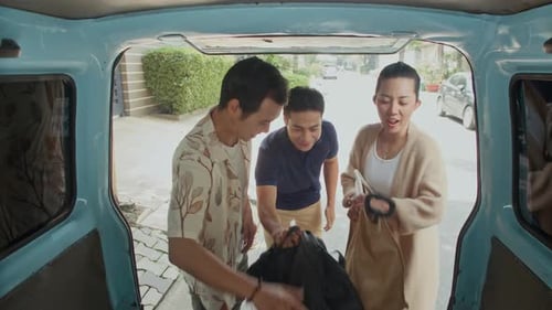 Three Asian People Packing Bags