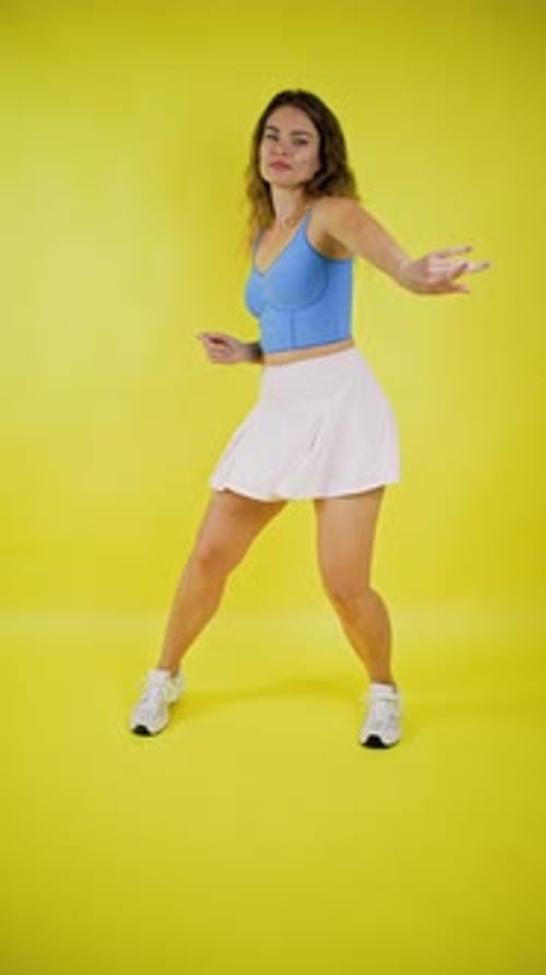 Woman Dancing Vigorously on Bright Yellow Background
