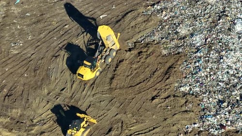 Trucks Move Dirt at Landfill Aerial View