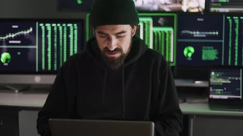 Young Hacker Man Breaking Into Corporate Servers From His Home Office