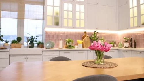 Beautiful tulips on wooden table in kitchen