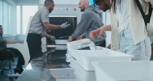 People Putting Personal Items for Metal Detector Scanning Airport Staff Controlling Screening