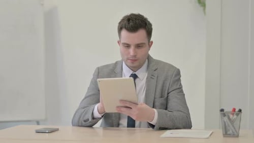 Young Adult Using Tablet in Office Setting