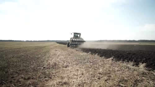 Tractors plowing the field in Ukraine