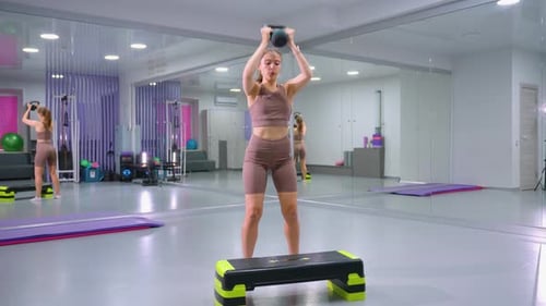 Woman Performing StepUp Exercise with Weight in Gym