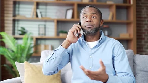 Man Talking on Smartphone Indoors in Mid Shot