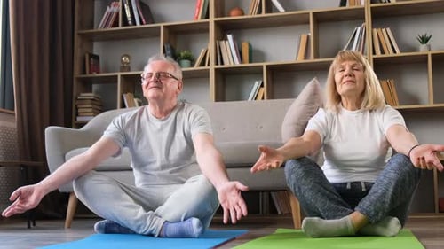 Senior Couple Meditating Together at Home